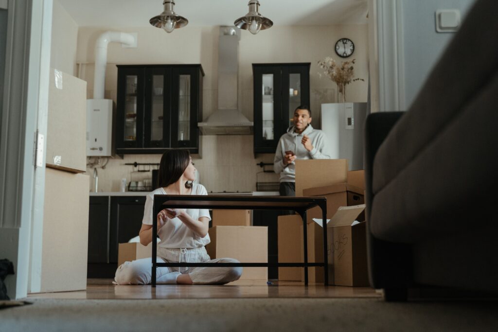 A couple comparing moving quotes on a laptop