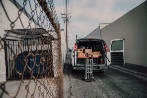 A long-distance moving truck being loaded outside a home